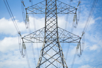 a high voltage power pylons against blue sky