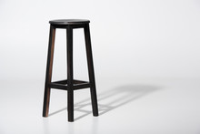 Studio Shot Of Classic Black Tall Wooden Barstool Standing On White