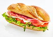 Baguette sandwich with serrano ham, cheese and vegetables