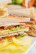 Club Sandwich On A Rustic Table In Bright Light