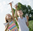 © JackF - two enthusiastic kids playing with simple paper planes