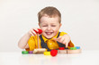 © oksanazahray - Three years old boy in yellow t-shirt  playing with colorful wooden toys