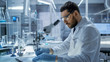 © Gorodenkoff - In a Modern Laboaratory Research Scientist Writes Down His Experiment Observations.