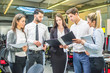 © Bojan - Business people having meeting in office. Group of young business people in formal wear standing and discussing documents.