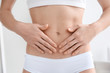 © Africa Studio - Closeup view of woman holding hands on her belly. Epilation concept