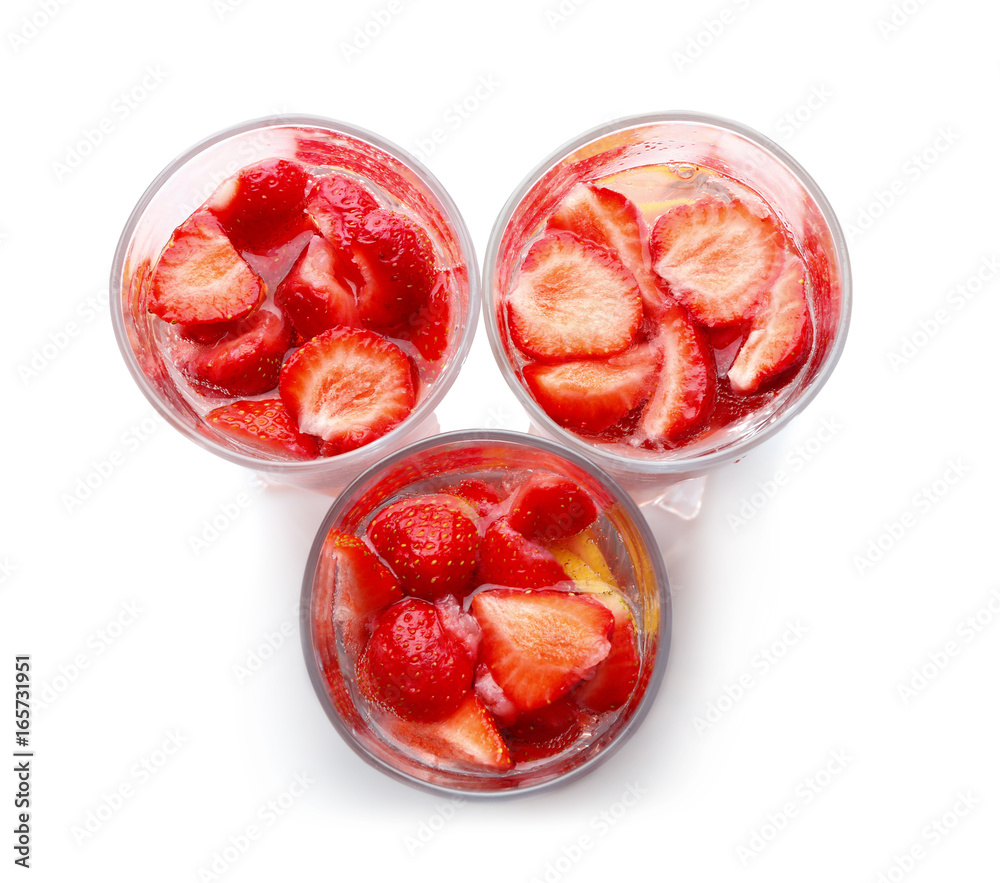 Three glasses of tasty strawberry lemonade on white background