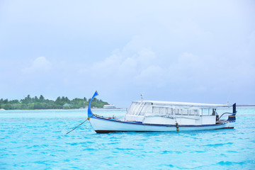 Canvas Print - Modern boat berthed at tropical resort