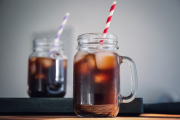 Poster - Mason jar with cold brew coffee and straw on wooden table