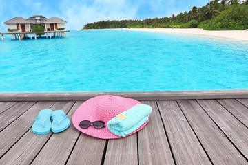 Canvas Print - Beach accessories on wooden pontoon at sea resort. Summer vacation concept