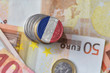 euro coin with national flag of france on the euro money banknotes background.