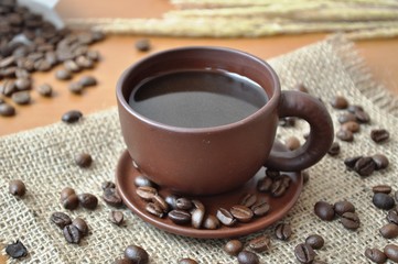 Cup of coffee on the table and coffee beans 