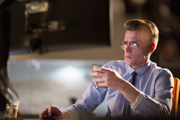 man using mobile phone in dark office