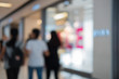 © obeyleesin - Shopping center with customers and seasonal sale promotions. Blurred, people unrecognizable