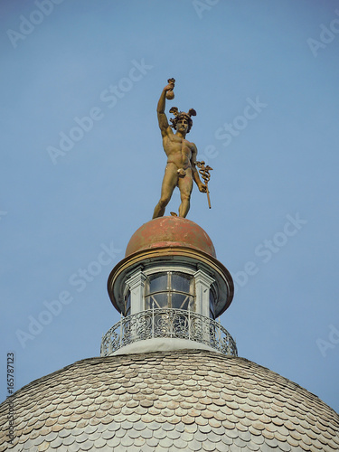 Fotomural Statue of Merkur/Hermes at the top of the dome of old building