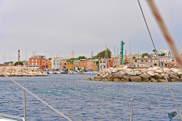 Wall Mural - Bright houses the masts of the yachts in Marina on the island of Procida