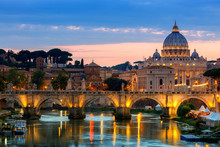 Night View Of Old Sant' Angelo Bridge  And St. Peter's Cathedral In Vatican City Rome Italy.