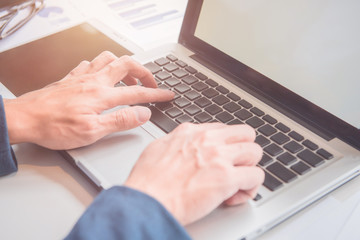 man working bussiness in office with computer notebook and document data on table