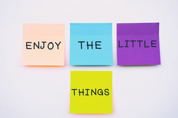 Wall Mural - Enjoy the little things - Inspirational and motivation quotes on colorful sticky paper on a wall, pastel colors.