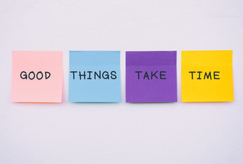 Wall Mural - Good things take time - Inspirational and motivation quotes on colorful sticky paper on a wall, pastel colors.