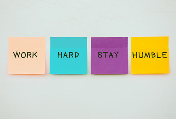 Wall Mural - Work hard stay humble - Inspirational and motivation quotes on colorful sticky paper on a wall, pastel colors.