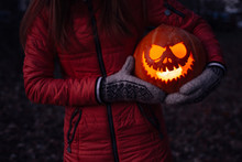 Woman Hugs Carved Halloween Pumpkin