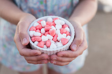 Candy Hearts In A Bowl In Hands