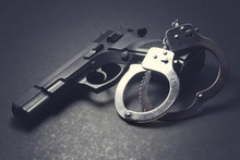 Handgun With Handcuffs On Dark Background, Crime Concept, Law Enforcement