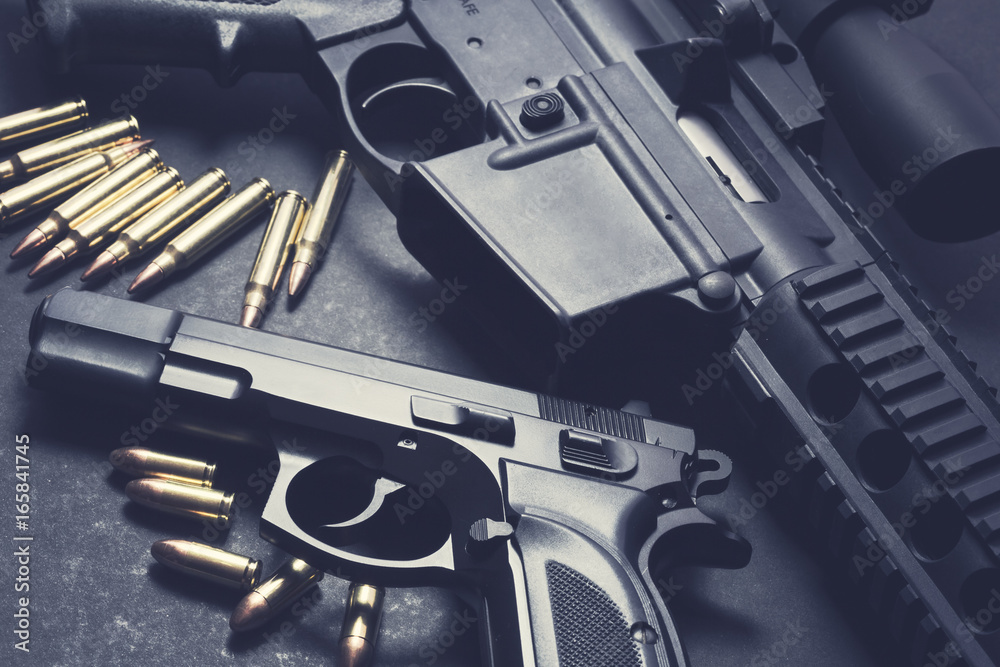Handgun with rifle and ammunition on dark background - obrazy, fototapety, plakaty 
