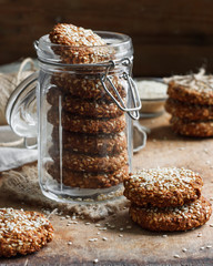 Wall Mural - homemade cookies with sesame seeds in a glass jar