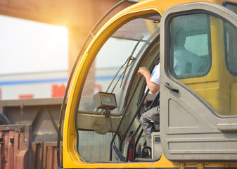 SEREMBAN, MALAYSIA - JANUARY 22, 2016: Operator operate his crane from the crane driver cockpit.