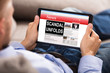 Man Reading Unfolds Scandal News On Digital Tablet