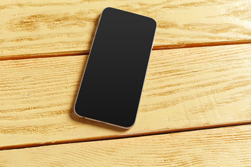 Wall Mural - Smartphone on wooden background. Top view