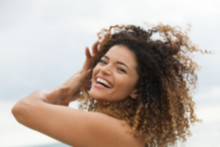 Out Of Focus Portrait Of Happy Woman Laughing In Summertime