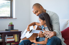 Father Playing Guitar With Daughter