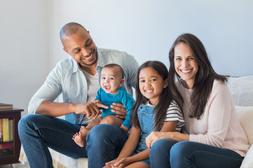 Wall Mural - Happy multiethnic family on sofa