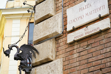 Sticker - Dragon figurine and Piazza Giacomo Matteotti Street sign wall Siena