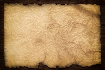 Wall Mural - old paper on the wood background, ancient scroll