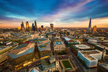 Wall Mural - London, England - Panoramic kyline view of the famous financial bank district of London at golden hour. This view includes famous skyscrapers, office buildings and beautiful colorful sky after sunset