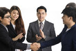 © Jestercine - Businessmen hand shaking after striking grand deal with business team. isolated on white.