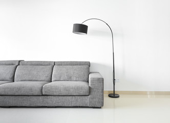 Modern and clean decoration of an apartment with a sofa and a lamp