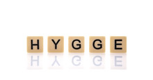 HYGGE  Spelt On Word Tiles On A White Background, Hygge Is A Danish And Norwegian Word Which Can Be Described As A Quality Of Cosiness 