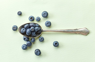 blueberries in silver spoon