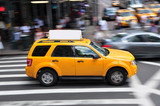 Fototapeta  - Panning shot of a taxicab at Times Square in New York, USA.