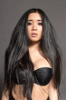 attractive Asian sexy fashion model with natural hair, full lips, perfect skin, posing in studio, wearing black underwear, beauty photo shot, retouched image