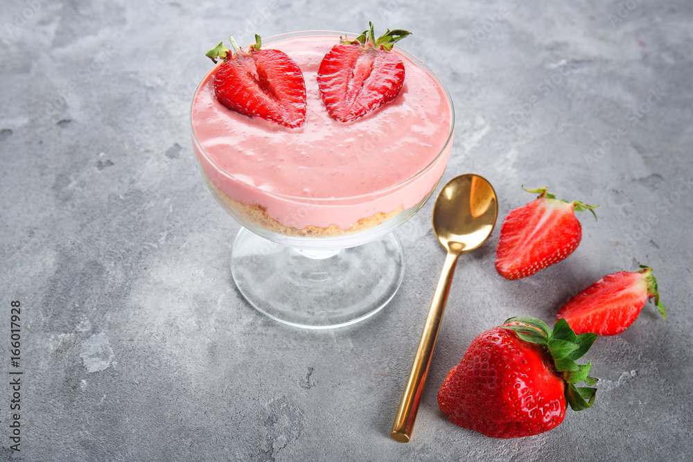 Dessert with yogurt and strawberries on grey background