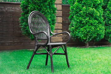 Canvas Print - Comfortable chair on grass lawn in park