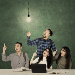 Canvas Print - Students sit under bright light bulb