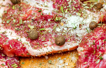 fresh raw meat on wooden cutting board