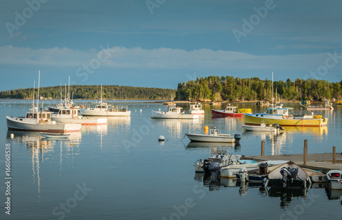 Fotografia, Obraz Lobster boats are moored in the harbor at dusk in Friendship, Maine