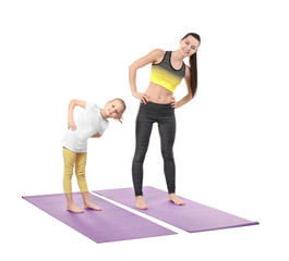 Poster - Mother and daughter doing exercise on white background